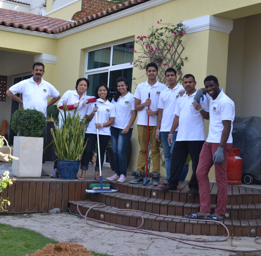 Associates from Courtyard by Marriott Dubai Green Community busy at work assisting the local community to clean up their homes