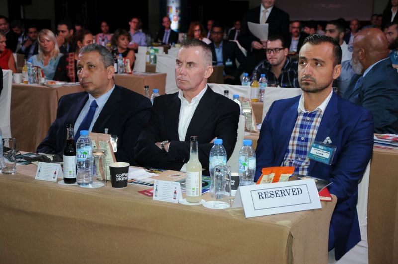 Gary Rhodes, Nicholas Couvaras and Dr. Basem in the front row of the audience at forum